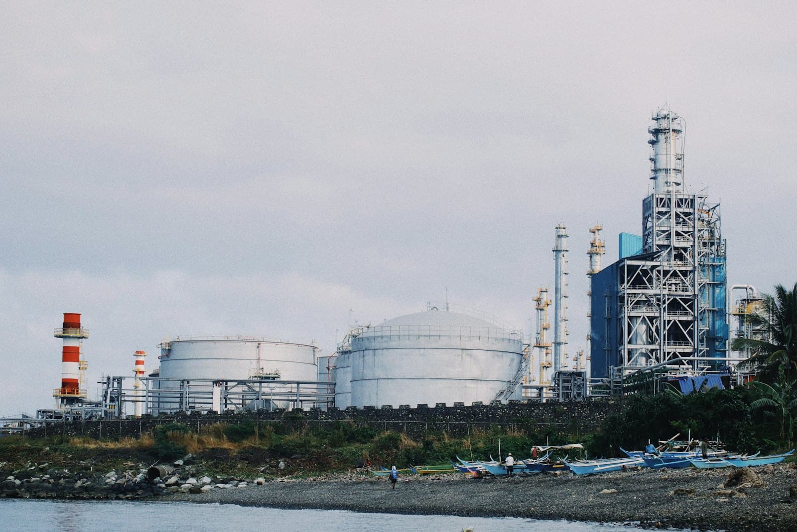 Large water treatment and storage facility on a coastline at dusk